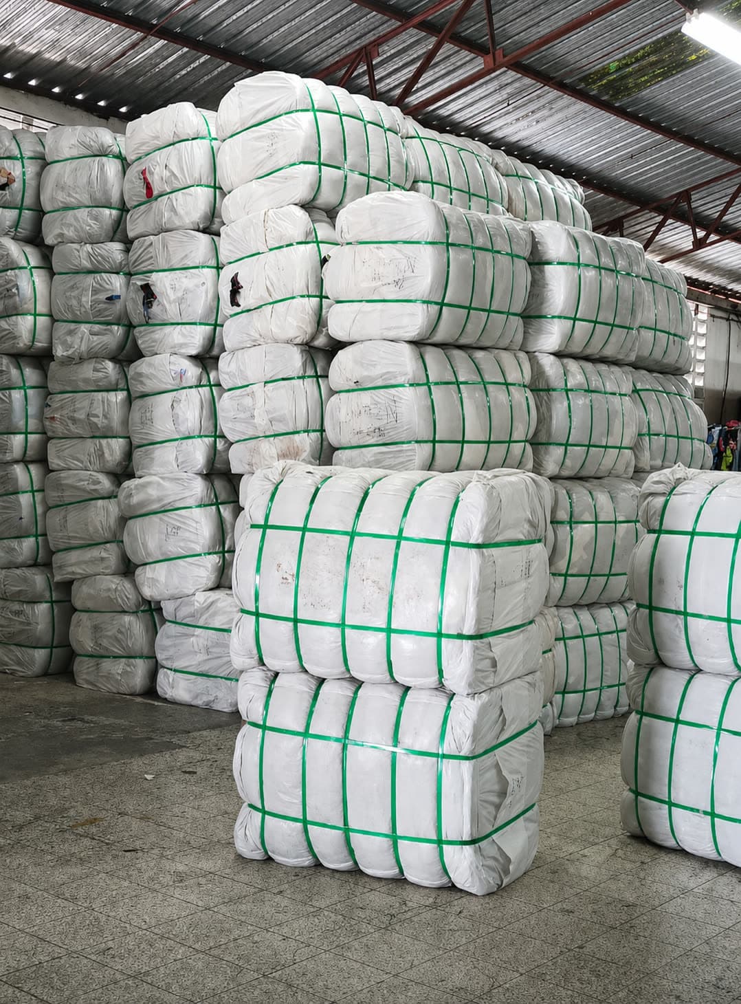 Strapped tropical mix bales stacked to the warehouse roof